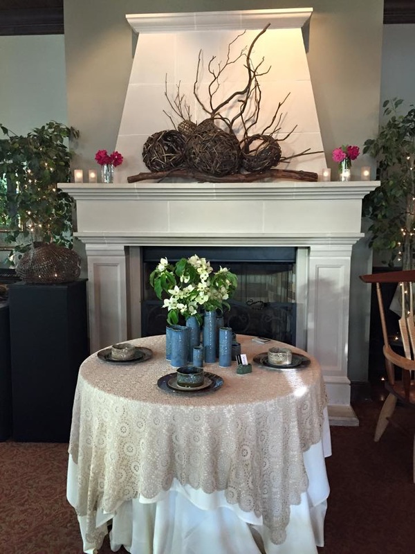 Fully Set Dinner Table In Front Of A Hearth With Fireplace Sculptures