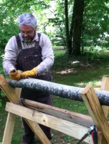 Artist Sawing A Log For Contemporary Rustic Decor