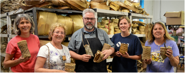 Matt Tommey stands with group who takes his weaving class in River Arts District of Asheville, NC.