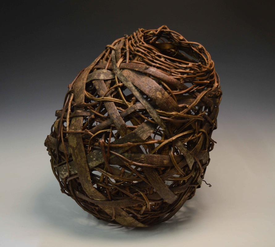 Large woven vessel made by Matt Tommey. This rustic sculpture is made of kudzu, mimosa bark, grapevine, and honeysuckle.