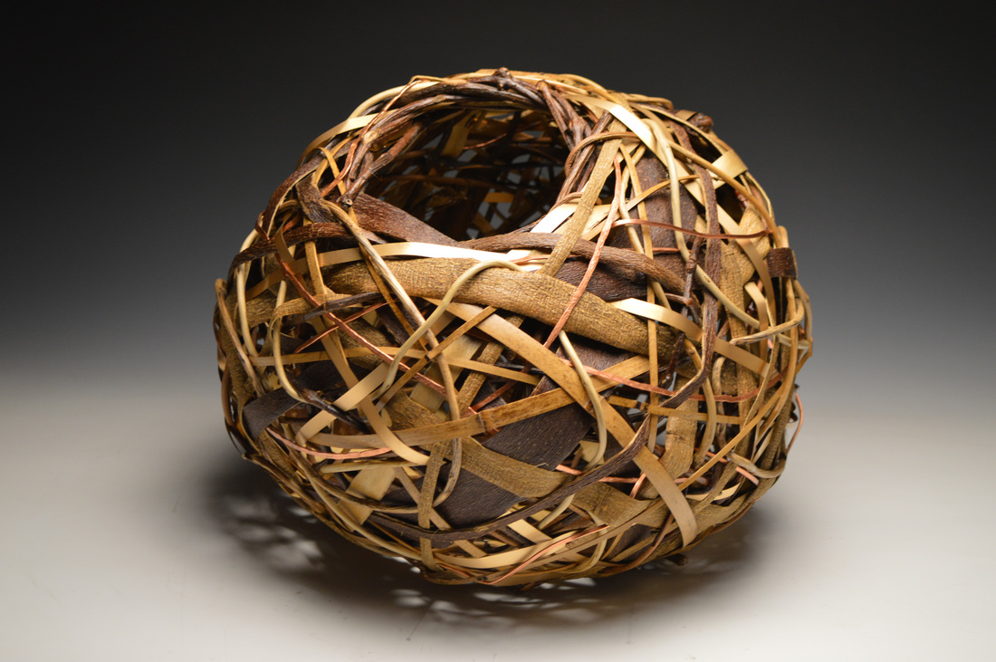 Matt Tommey of the River Art's District created this fine contemporary basket out of grapevine, random weave, vines and bark.