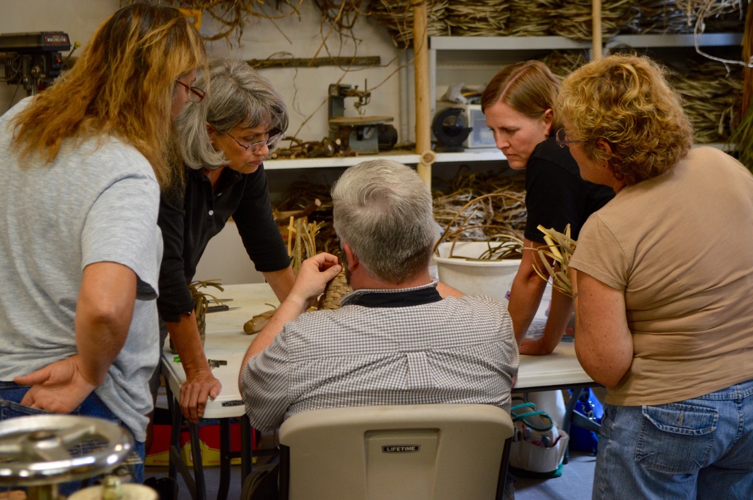 Matt Tommey in Asheville's River Arts District teaches a group of women how to weave a basket.