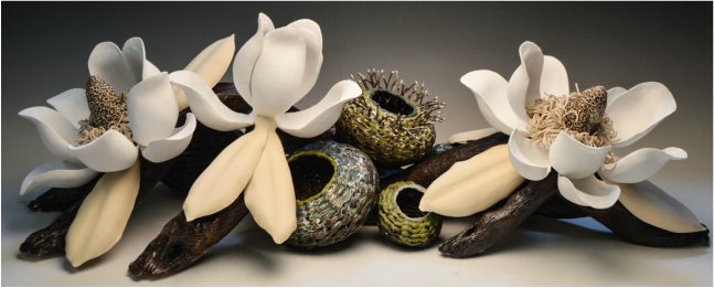 Porcelain magnolia blossoms and contemporary art baskets meet in a collaborative piece by Margie Bibb Johnson and Matt Tommey of Asheville, North Carolina's River Arts District.