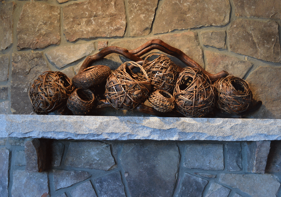 8 Baskets And A Large Branch As Fireplace Mantel Art