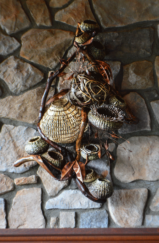wall sculpture decor featuring vine baskets against stone wall by Matt Tommey in Asheville, North Carolina's River Arts District.