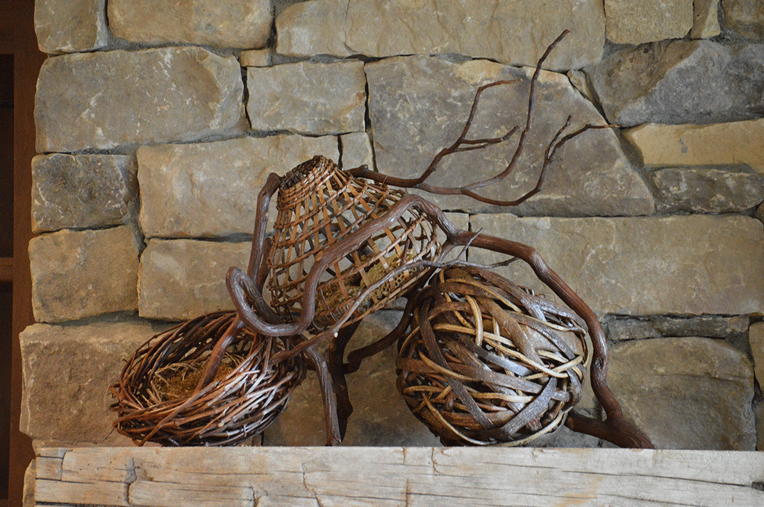 3 Woven Baskets With A Curved Branch As Fireaplce Mantel Art