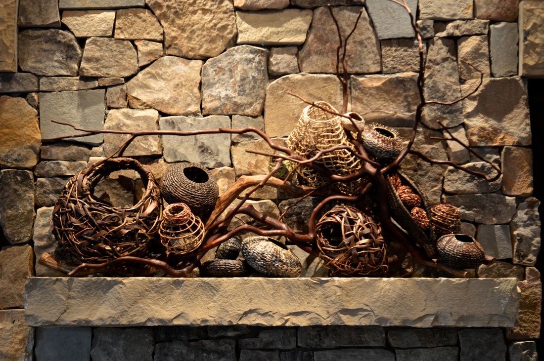 13 Wovens Baskets With Large Branches In Between Them As Fireplace Mantel Art